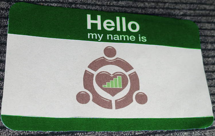 Photo was here of a nametag with words Hello My Name Is and in the area provided for a persons name it is instead a LoveSteps Logo.