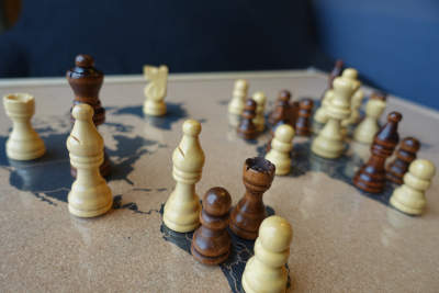 Image was here of a map with all the continents and countries in the world. Covering all the countries are chess pieces.