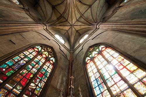 Image was here of a church high ceiling with ornate decoration and also sunlight shining through beautiful stained glass.