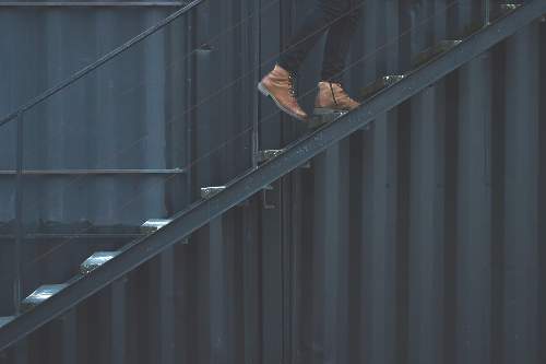 An image was here of someone with boots walking up steps.